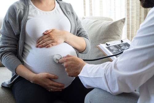 Pregnant woman being examined by a medical professional, illustrating what Group B Streptococcus (GBS) is and how it is identified during pregnancy.