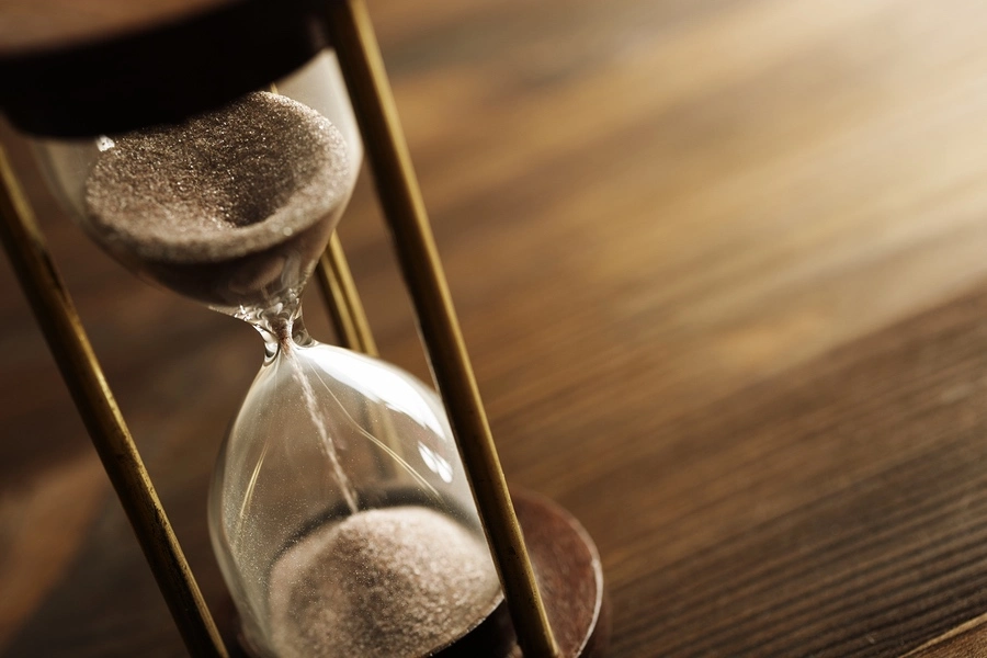 Hourglass resting on a desk, symbolizing the timeline and duration of a birth injury lawsuit.