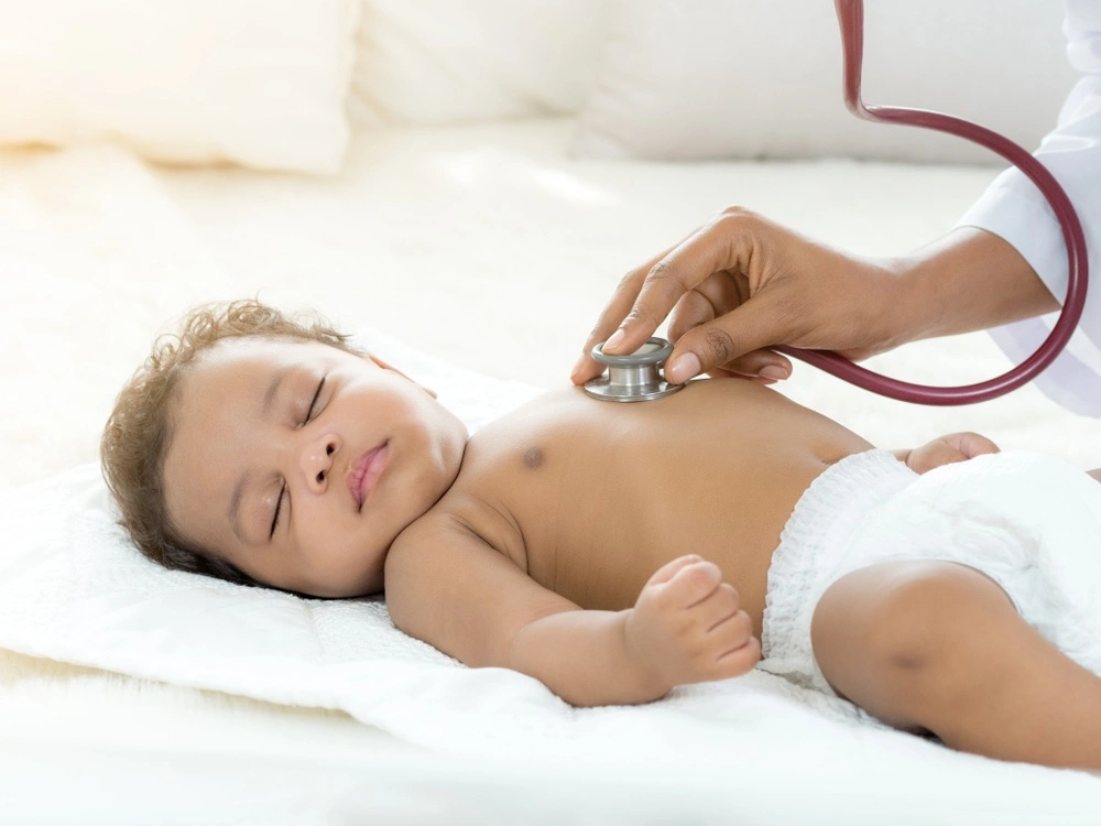 Newborn baby being examined by a medical professional, illustrating an overview of how Erb’s palsy is diagnosed and managed.