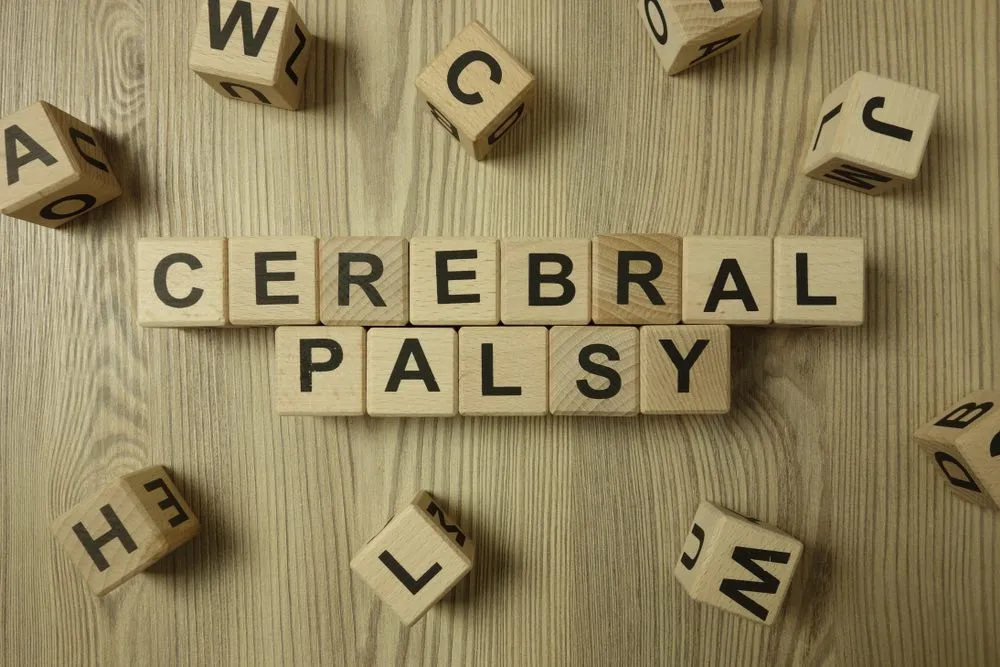 Letter cubes spelling cerebral palsy, illustrating the factors that can affect life expectancy for individuals with cerebral palsy.