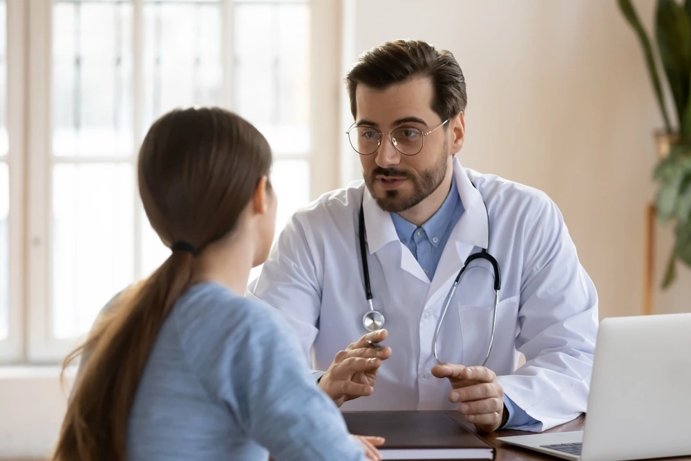 Woman speaking with a doctor during a medical consultation, illustrating when the use of forceps may become medical malpractice.