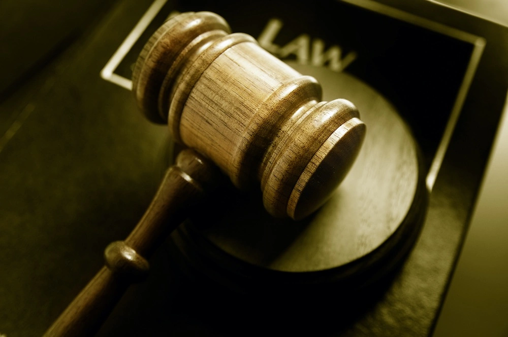 Gavel resting beside a law book, representing the legal concept of what the birth injury statute of limitations is.