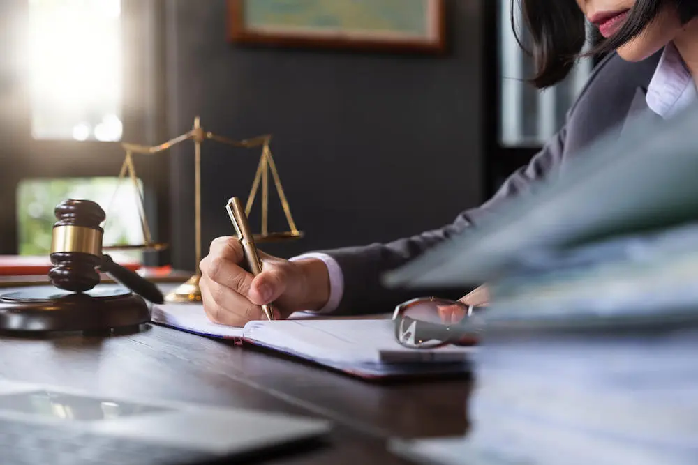 Lawyer reviewing case files at a desk, highlighting the importance of finding the right birth injury attorney to help maximize your settlement.